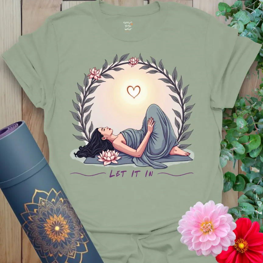 Calm sage green yoga t-shirt with heart-opening yogi and soft sunrise artwork symbolizing mindful acceptance and conscious growth.