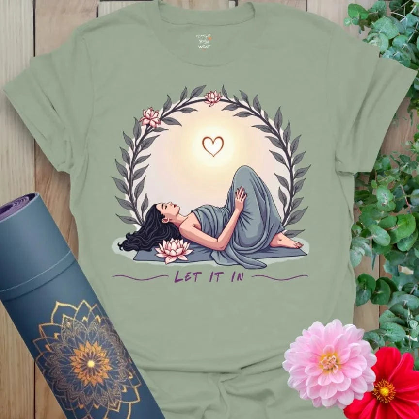 Calm sage green yoga t-shirt with heart-opening yogi and soft sunrise artwork symbolizing mindful acceptance and conscious growth.