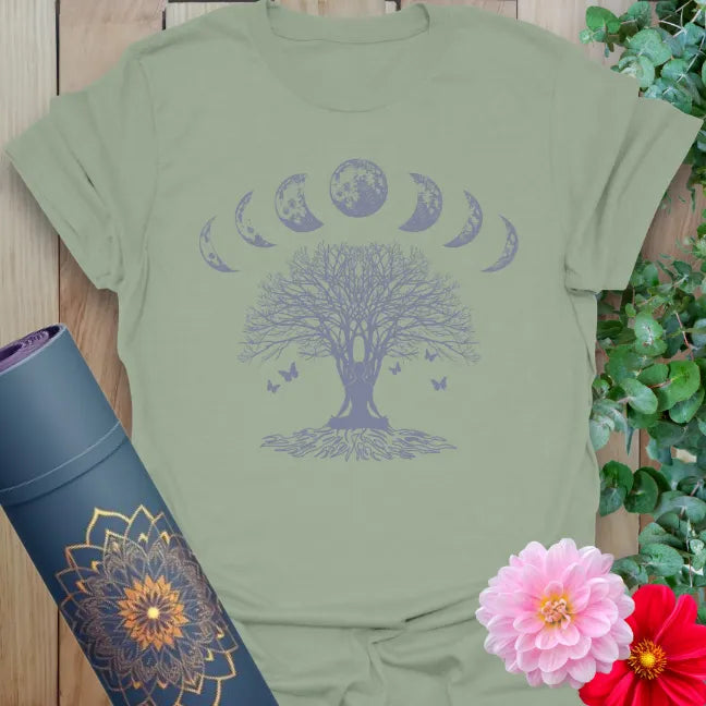Calm sage green yoga t-shirt featuring rooted tree of life and moon phase design inspiring grounded spiritual presence and conscious movement.