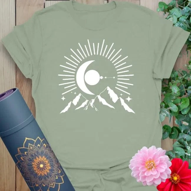 Calm sage green yoga t-shirt featuring powerful moon rising over mountains symbolizing soulful growth, intuition, and adventure.