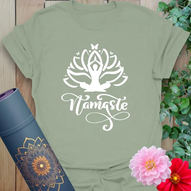 Calm sage green yoga t-shirt featuring yogi rising from lotus flower with "Namaste" message for soulful, graceful living.