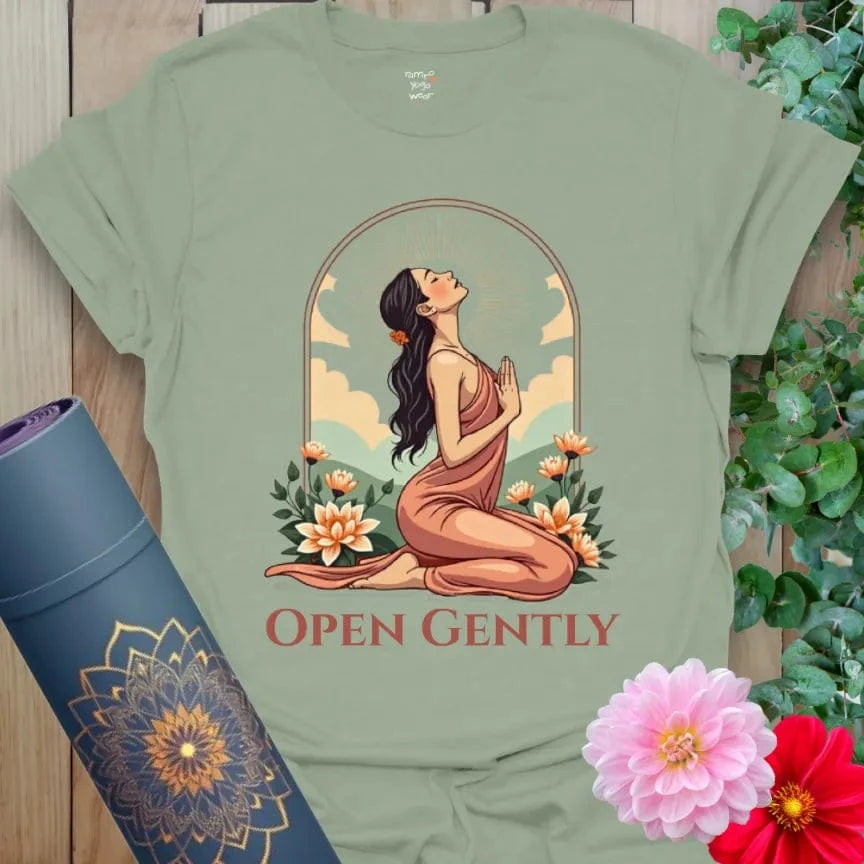 Calm sage green yoga t-shirt featuring soulful heart-opening figure and vibrant floral surroundings for peaceful, heart-led growth.