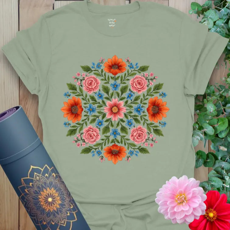 Calm sage green yoga t-shirt featuring vibrant floral symmetry symbolizing grounded growth, peace, and mindful expansion.