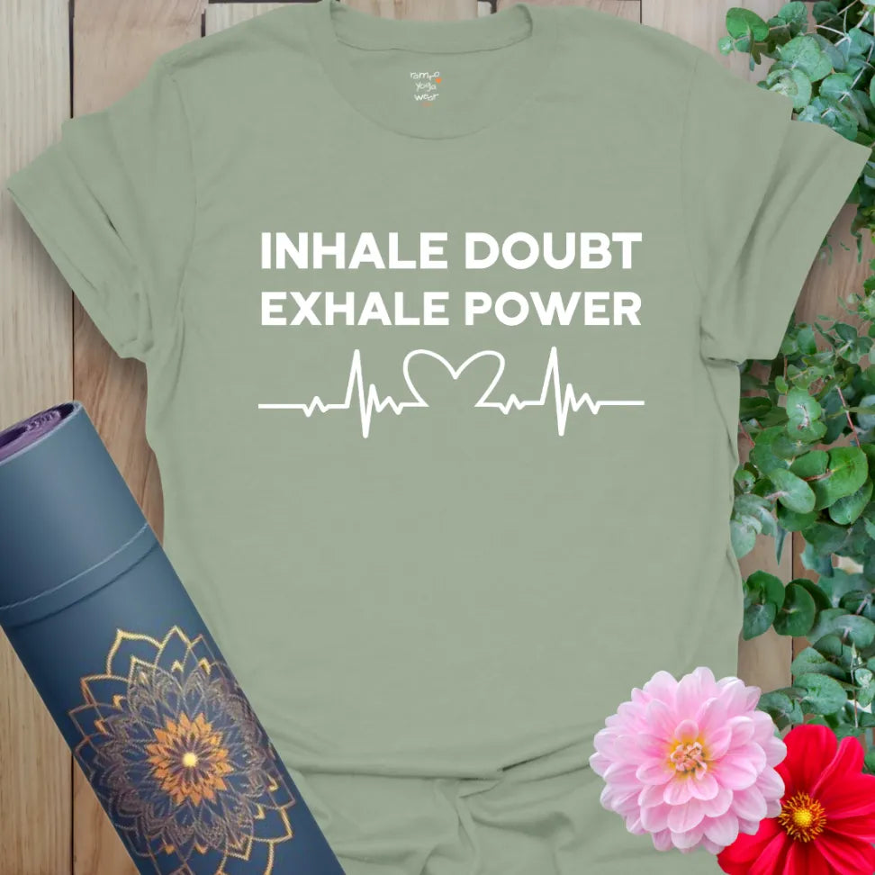 Calm sage green yoga t-shirt featuring inspirational quote and heartbeat graphic encouraging strength, presence, and soulful courage.