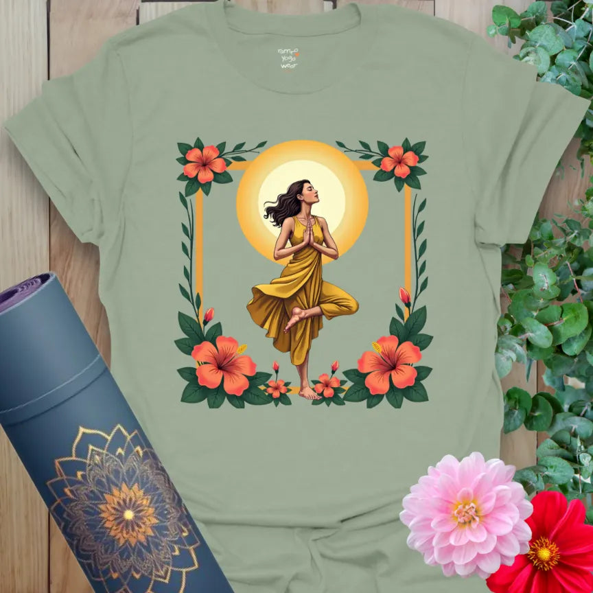 Calm sage green yoga t-shirt featuring serene tree pose yogi surrounded by flowers and sun symbolizing grounded radiant living.