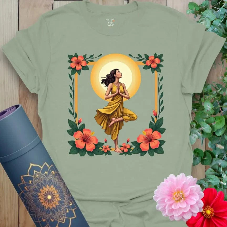 Calm sage green yoga t-shirt featuring serene tree pose yogi surrounded by flowers and sun symbolizing grounded radiant living.