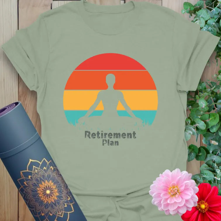 Calm sage green yoga t-shirt featuring meditating figure against sunset backdrop symbolizing soulful retirement dreams and mindful goals.