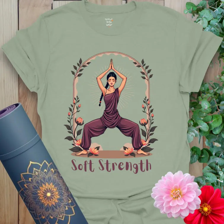 Calm sage green yoga t-shirt featuring Goddess Pose silhouette and “Soft Strength” text for conscious feminine empowerment and inner calm.