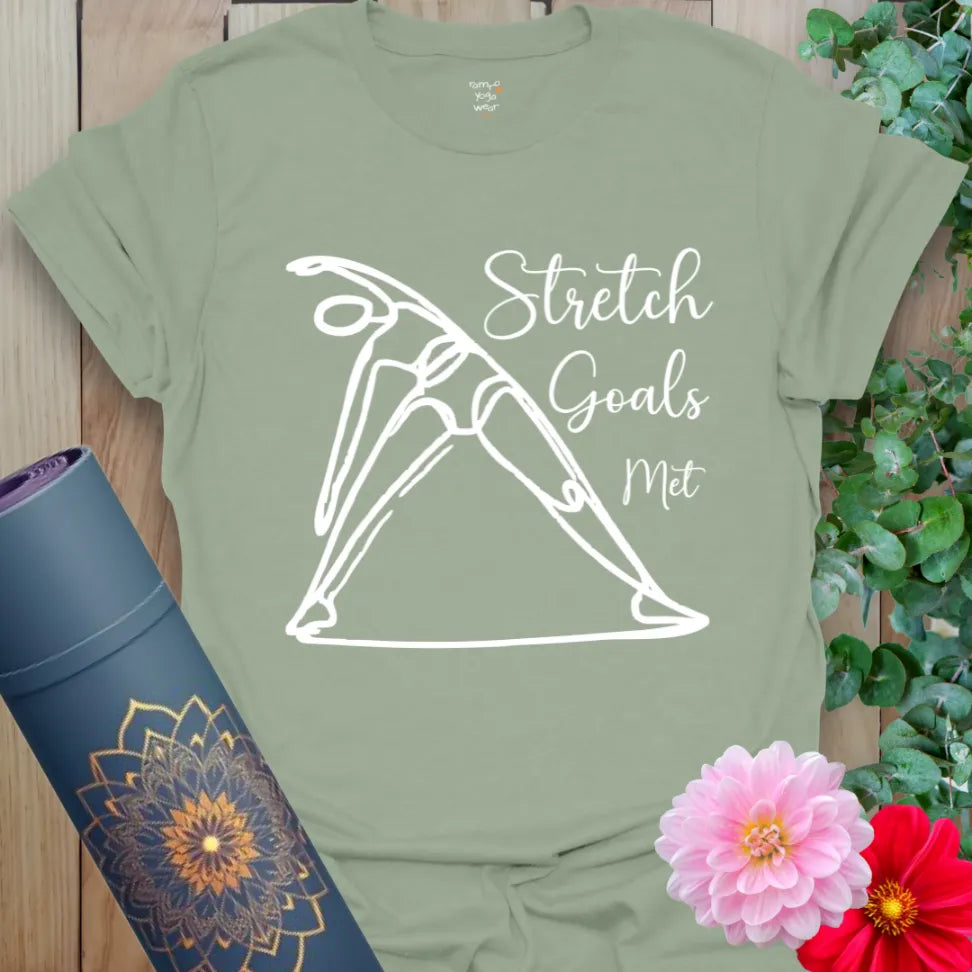 Sage green cotton tee with Triangle Pose line art and funny “Stretch Goals Met” mantra for flexible, soulful movement.
