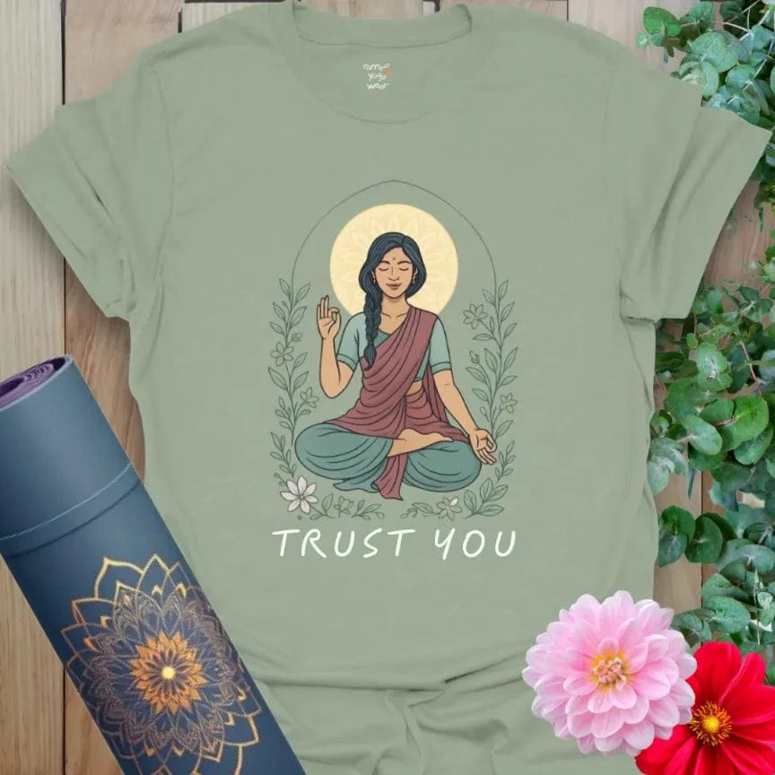 Sage green yoga tee featuring meditating woman with glowing halo and “Trust You” design for healing, grounding energy.