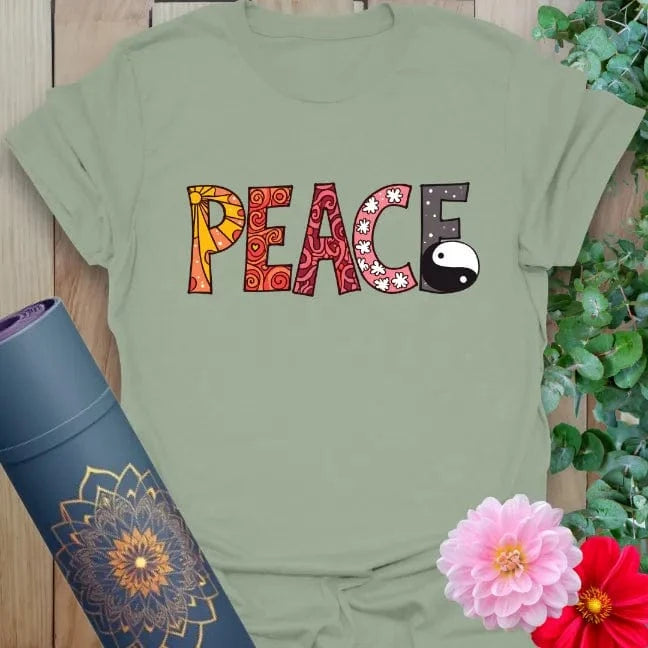 Sage green yoga t-shirt with creative “PEACE” text and yin yang symbol for calm, conscious balance.