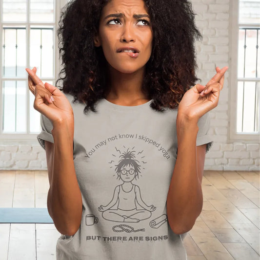 Woman wearing a short sleeved tee called the Signs T-Shirt in Ice Grey in the yoga studio — The Vault collection by Ramro Yoga Wear