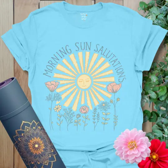 Sky Morning Sun Salutations T-Shirt with glowing sun and wildflowers in calming pastel tones. Yoga shirt celebrating balance and peace.