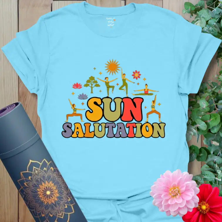 Sky Sun Salutation T-Shirt with cheerful sunrise and floral yoga art. A breezy blue tee for sunny morning flows and gratitude.