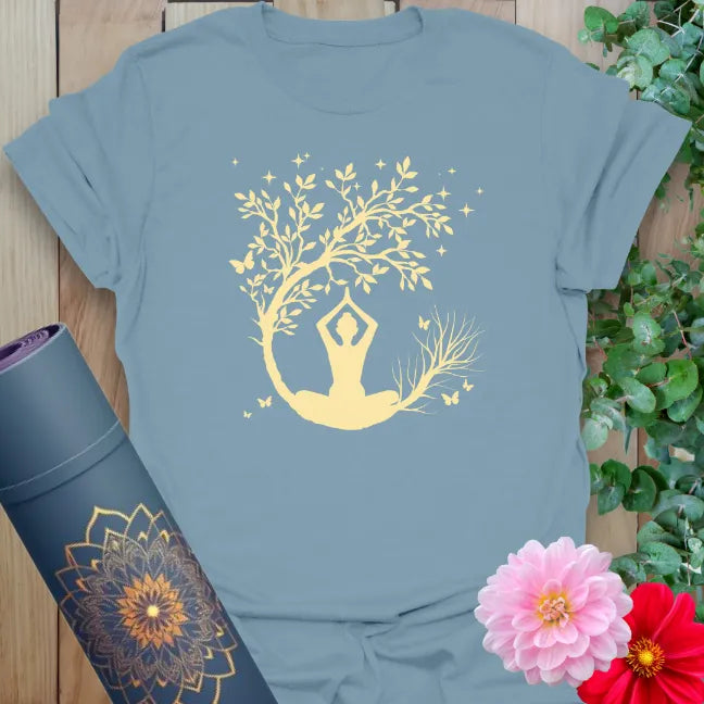 Muted stone blue yoga t-shirt with twilight meditation artwork and blossoming tree symbolizing calm and transformation.