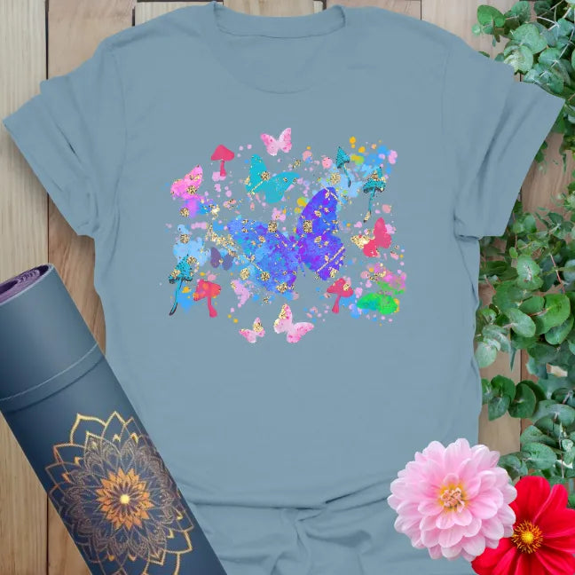 Muted stone blue yoga t-shirt featuring joyful butterfly and nature collage symbolizing freedom, lightness, and mindful journeying.
