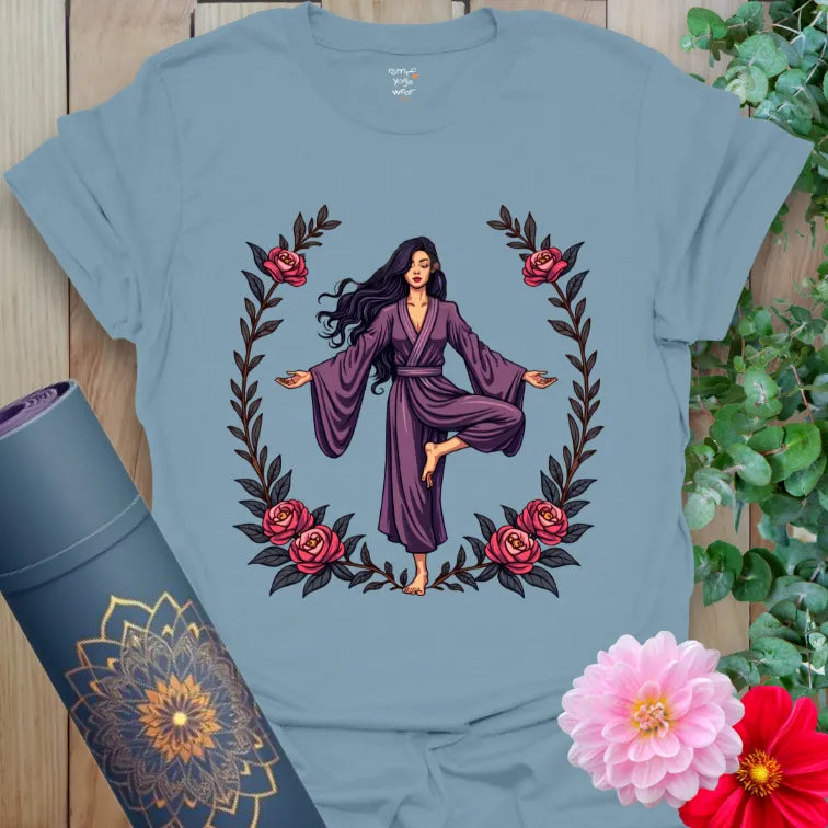 Muted stone blue yoga t-shirt featuring graceful yogi framed by roses inspiring mindful movement and empowered presence.