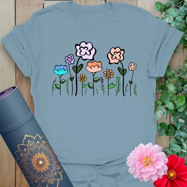 Muted stone blue yoga t-shirt featuring playful wildflower design for earth-connected movement and soulful expression.