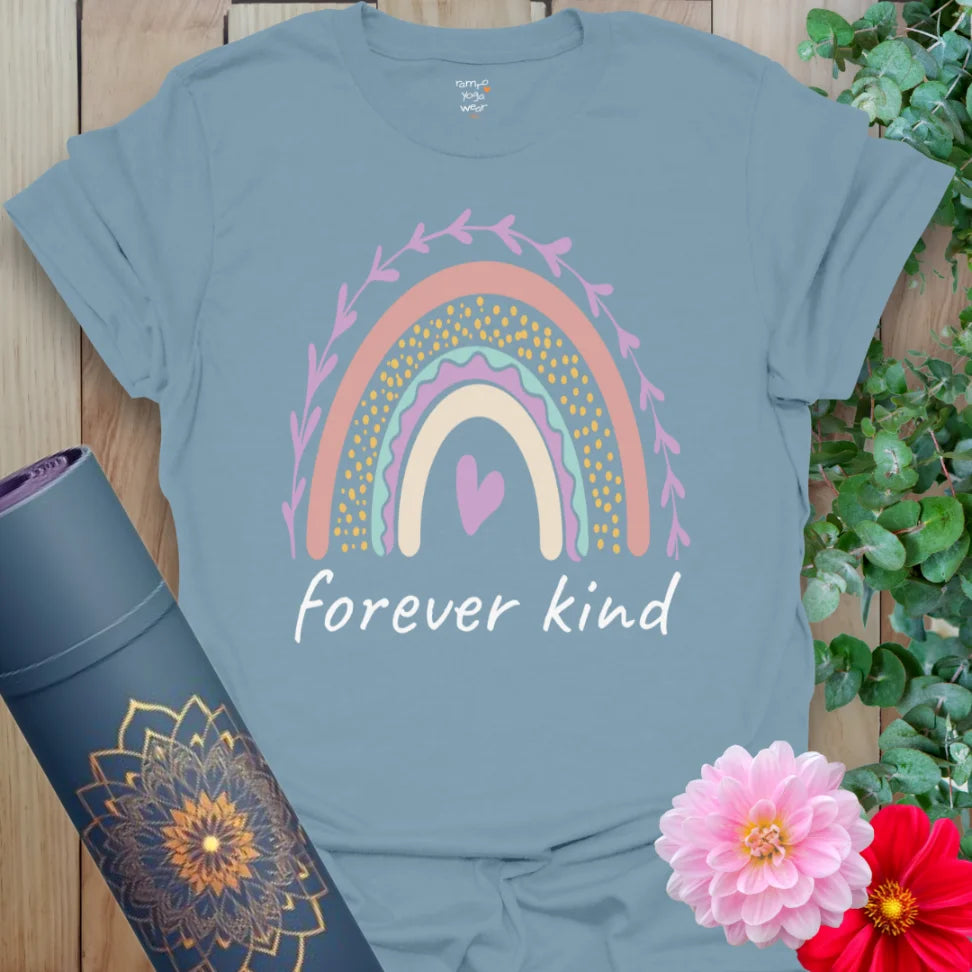 Muted stone blue yoga t-shirt featuring whimsical rainbow and heart design symbolizing soulful kindness and mindful presence.