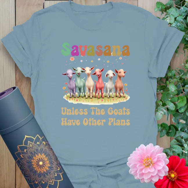 Muted stone blue yoga t-shirt featuring fun goat lineup and "Savasana" humor perfect for lighthearted yogis.