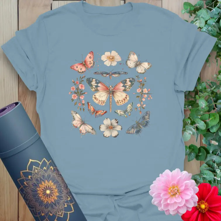 Muted stone blue yoga t-shirt featuring delicate butterfly and floral wreath symbolizing soulful growth and good fortune.