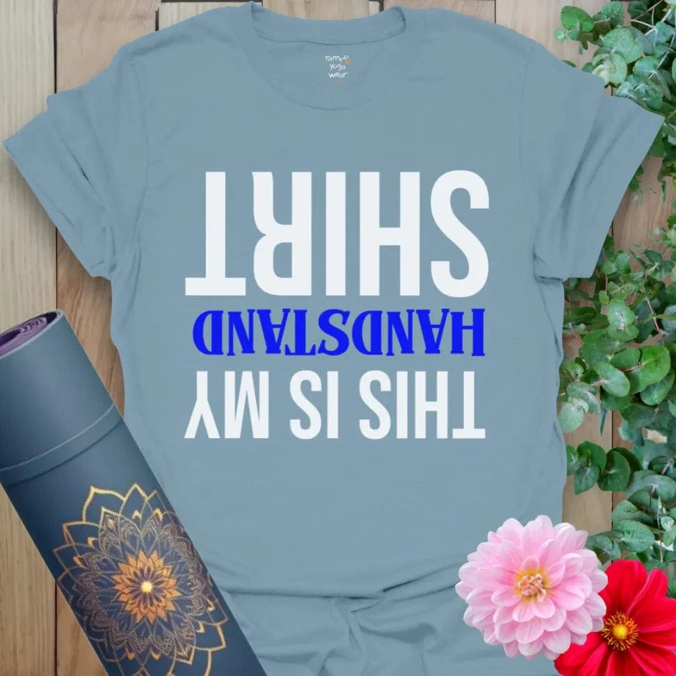 Muted stone blue yoga t-shirt featuring upside-down yoga humor design inspiring joyful, mindful expression.