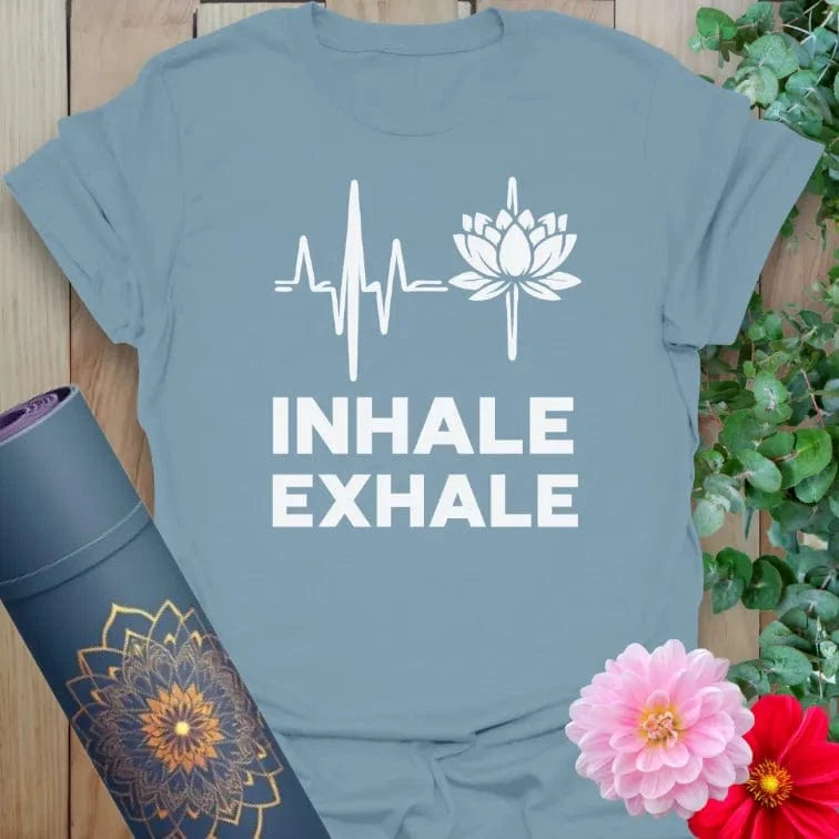 Muted stone blue yoga t-shirt with serene "Inhale Exhale" lotus graphic symbolizing peace, breath, and soulful living.