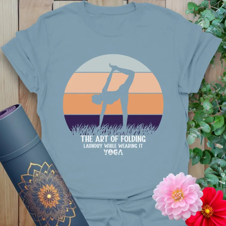 Muted stone blue yoga t-shirt with retro yogi silhouette and folding laundry humor for soulful, light-hearted yoga lovers.