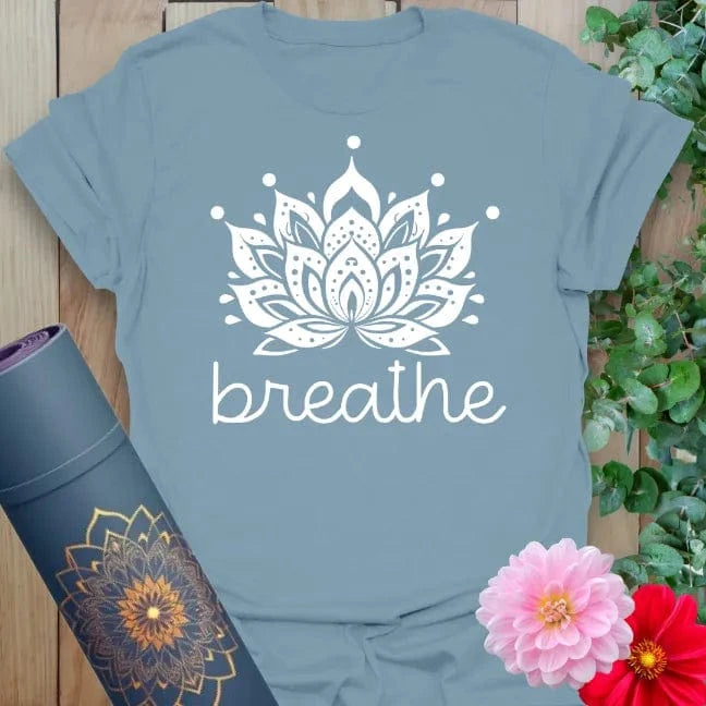 Muted stone blue yoga t-shirt featuring intricate lotus flower and "breathe" message for soulful, mindful movement.