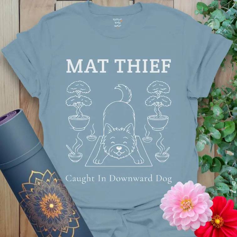 Stone Blue Mat Thief T-Shirt showcasing a dog stealing the yoga mat; clean, soft line art for dog-loving yogis.