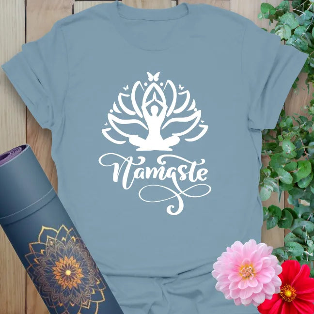 Muted stone blue yoga t-shirt with sacred lotus, yoga figure, and Namaste script inspiring conscious, peaceful living.