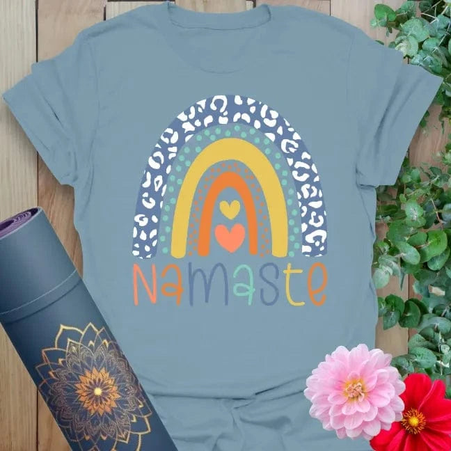 Muted stone blue yoga t-shirt with colorful rainbow and Namaste affirmation inspiring conscious, joyful soulful journeys.