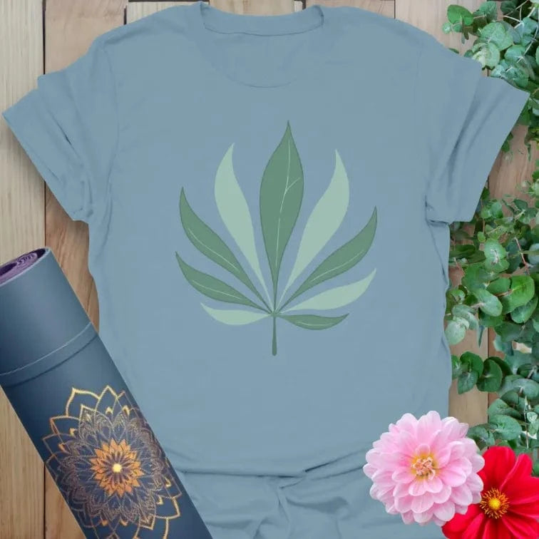 Muted stone blue yoga t-shirt showcasing palm leaf symbol representing natural balance, mindful movement, and soulful growth.