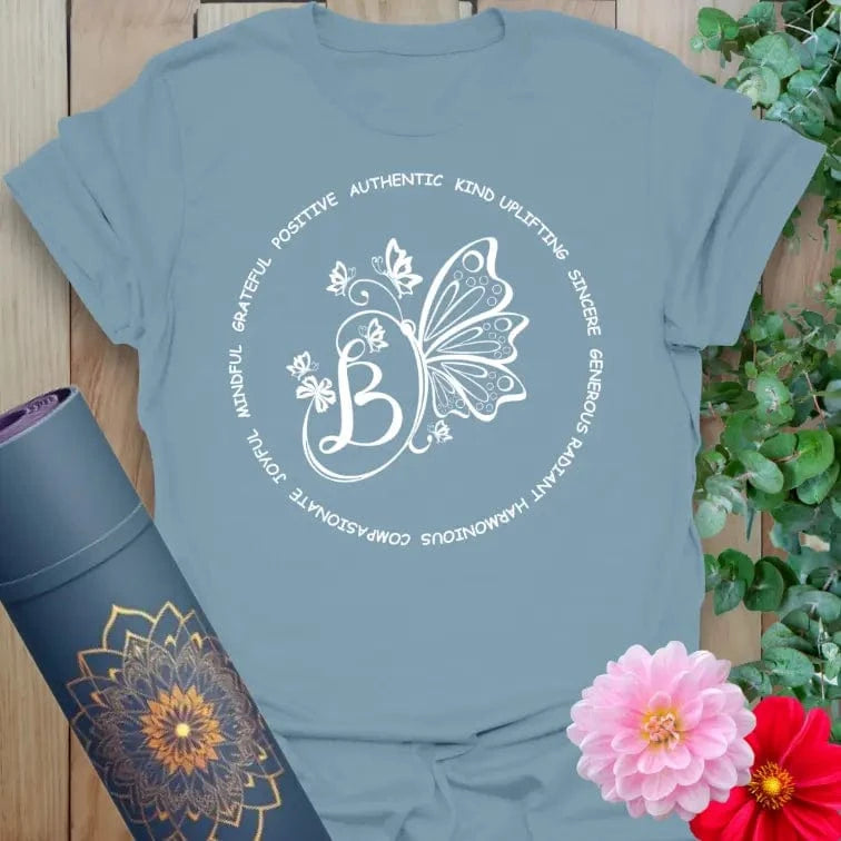 Muted stone blue yoga t-shirt featuring positive affirmations and butterfly symbol for conscious, mindful, and uplifting journeys.