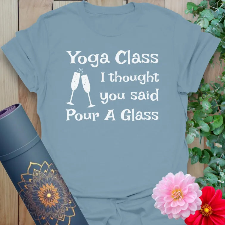 Muted stone blue yoga t-shirt featuring funny "Yoga Class / Pour A Glass" quote and bubbly toast artwork for balanced, soulful fun.