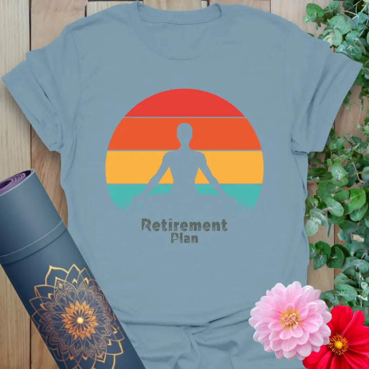 Muted stone blue yoga t-shirt featuring meditating figure and retro sunset design promoting peace, presence, and conscious living.