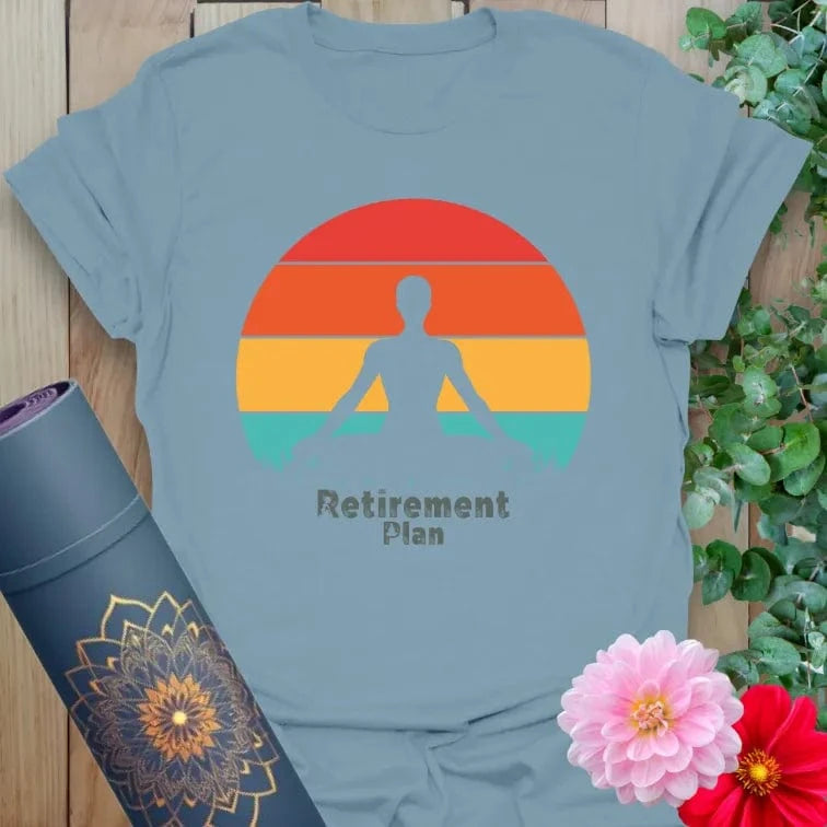 Muted stone blue yoga t-shirt featuring meditating figure and retro sunset design promoting peace, presence, and conscious living.