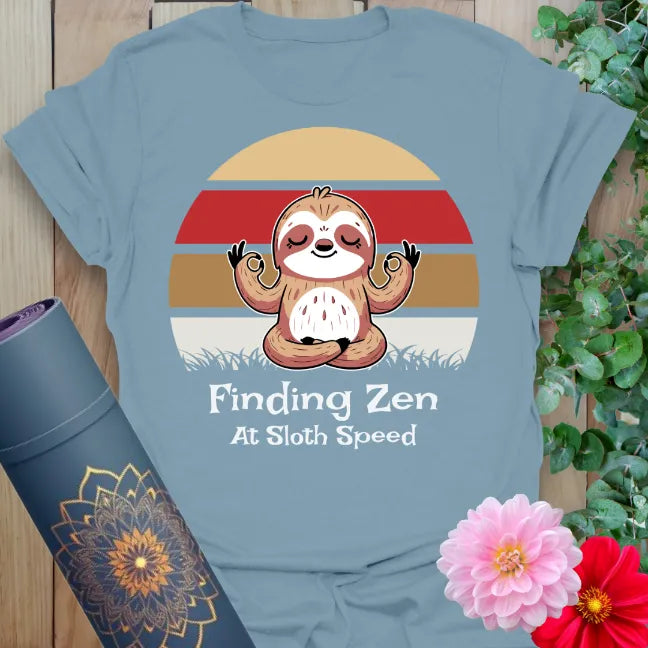 Muted stone blue yoga t-shirt with playful sloth design inspiring slow movement, joyful mindfulness, and sweet soul flow.