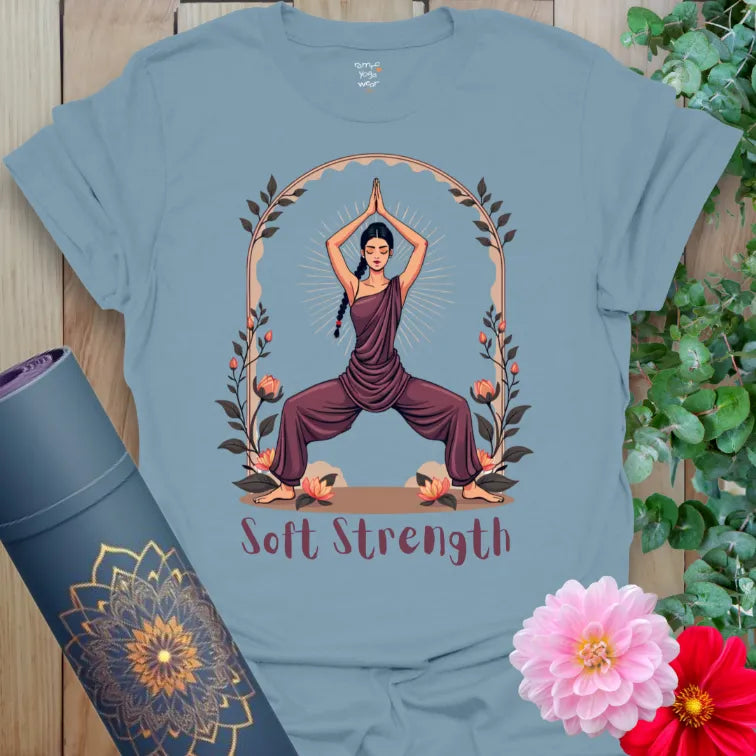 Muted stone blue yoga t-shirt showcasing feminine yoga warrior design with “Soft Strength” affirmation for mindful balance and empowered presence.