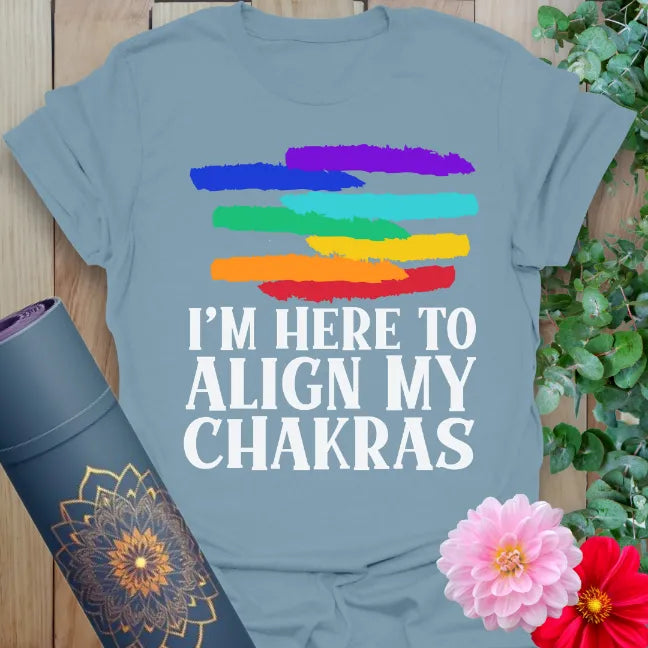 Muted stone blue yoga t-shirt with colorful chakra-inspired brush design and funny spiritual mantra for joyful alignment.