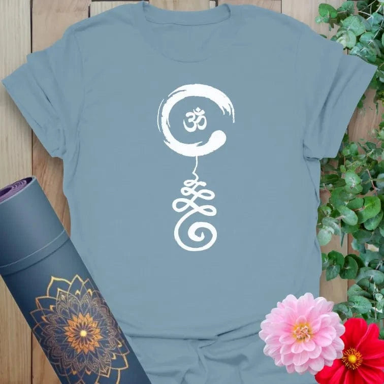 Muted stone blue yoga t-shirt featuring symbolic Om-based artwork for intuitive living and conscious movement.