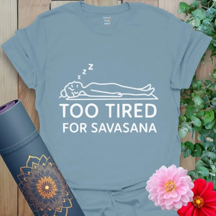 Stone Blue Too Tired T-Shirt with reclining yoga silhouette and witty “Too Tired for Savasana” slogan. Yoga humor tee.
