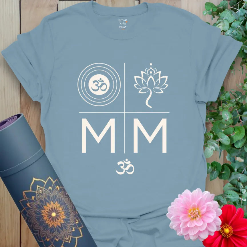 Stone Blue tee with cream spiritual symbols — Om in rings, lotus, mirrored M’s and mantra energy. Bold and balanced.