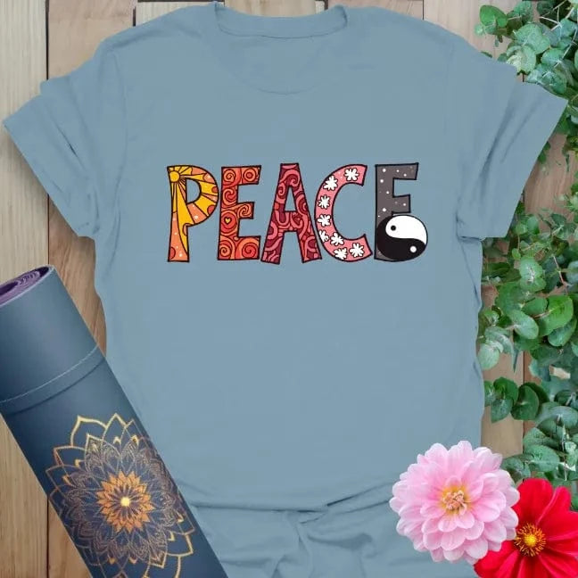 Muted stone blue t-shirt featuring artistic peace text with yin yang element for expressive, soulful wear.