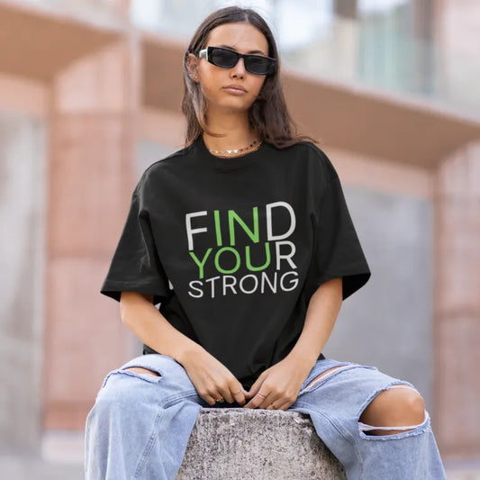 Woman wearing the Strong T-Shirt in Black, sitting outdoors with sunglasses — The Vault collection by Ramro Yoga Wear
