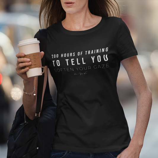 Woman wearing Studio Black yoga teacher gift tee on a city street holding coffee — Yoga Teacher Gifts collection by Ramro Yoga Wear
