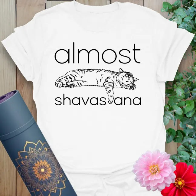 White Almost Shavasana T-Shirt – relaxed fit yoga tee with meditative savasana pose and fun graphic