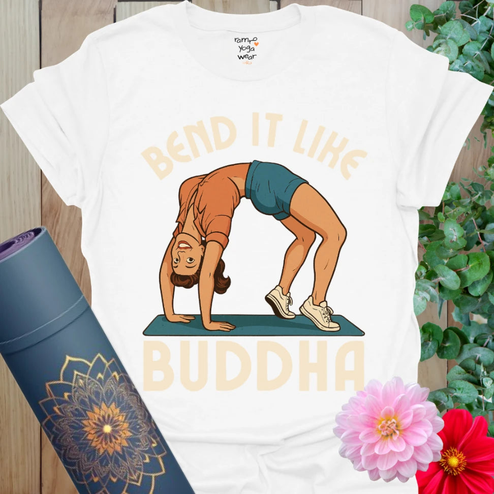 Crisp white yoga tee with playful pinup yogi in backbend and âBend It Like Buddhaâ retro-style design.