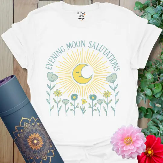White Evening Moon Salutations T-Shirt featuring a hand-drawn moon with radiating beams and wildflowers below. Soft yoga tee celebrating peaceful evenings.