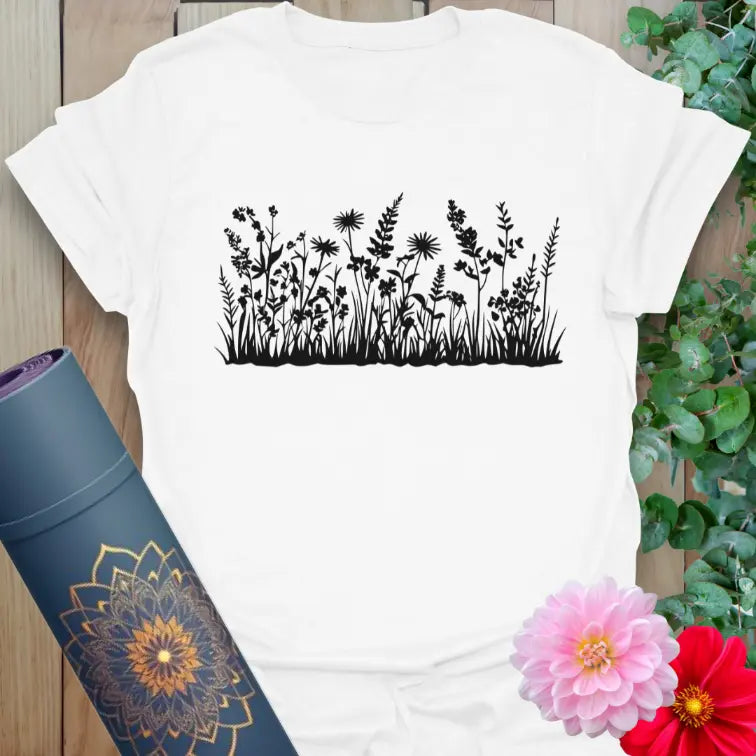 Clean white unisex yoga t-shirt featuring delicate field flower and grass design for nature lovers and mindful adventurers.